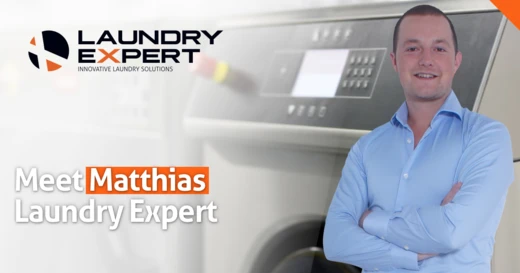 Man met gekruiste armen naast een wasmachine, met tekst "Matthias"